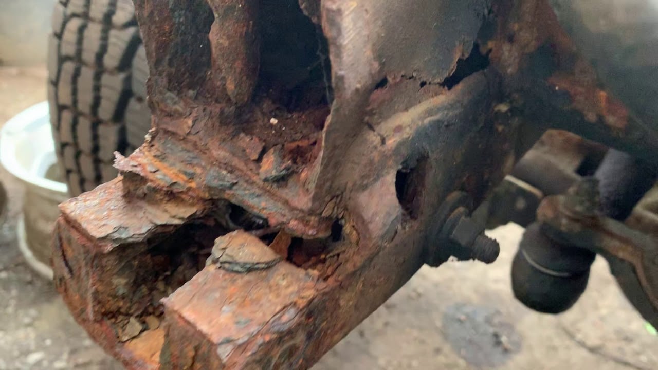 Close-up of Defender chassis showing common rust spots and mechanical wear